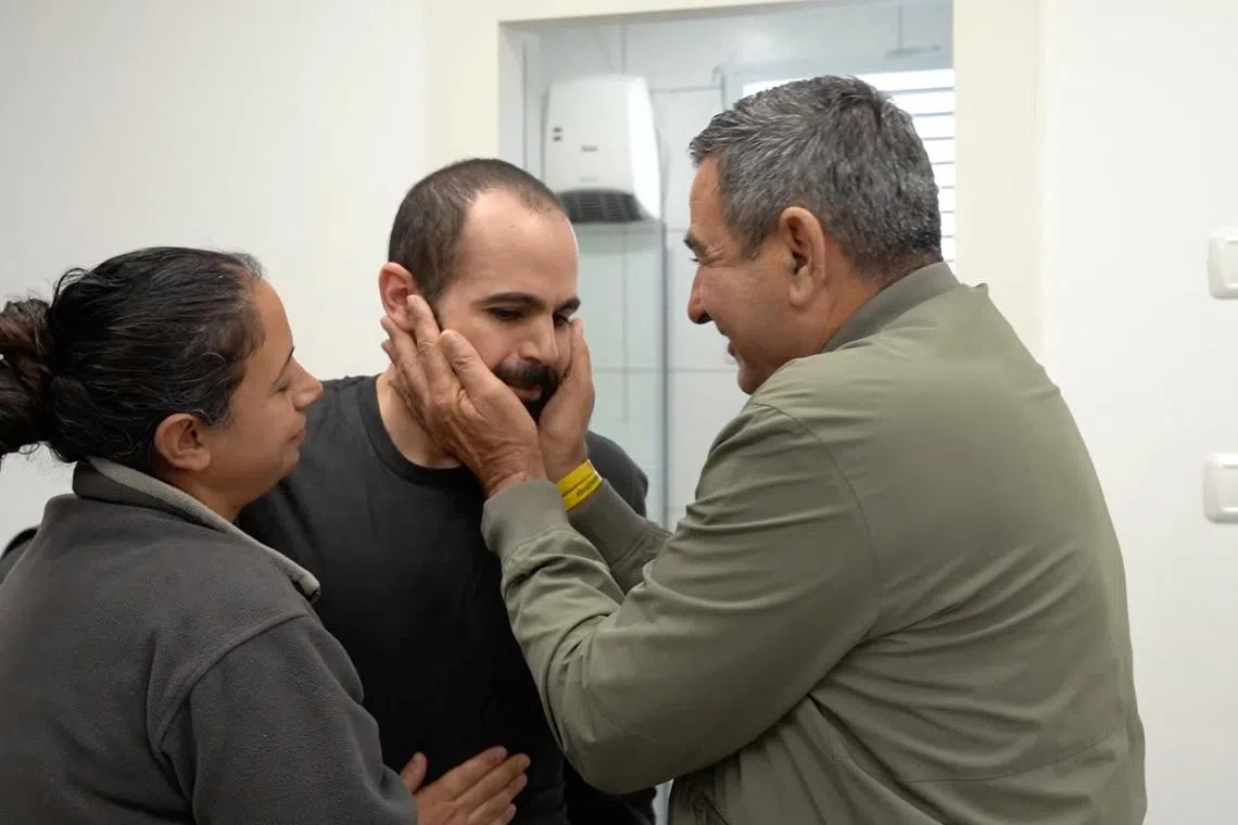 Released Israeli hostage Yarden Bibas, who was seized during the deadly October 7, 2023 attack by Hamas, embraces loved ones in an unknown location, in this screengrab from a handout video obtained by Reuters on February 1, 2025. Israel Defense Forces/Handout via REUTERS