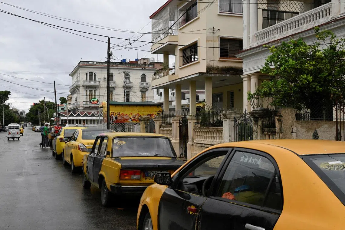 Taxi drivers wait in line for fuel outside a gas station, after U.S. President Donald Trump vowed to stop Venezuelan oil and money from reaching the island as Cubans brace for worsening fuel shortages amid regular power outages, in Havana, Cuba January 12, 2026. REUTERS/Norlys Perez