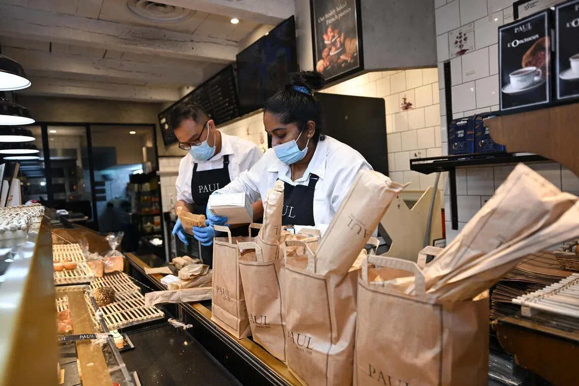 Staff packing surprise bags for distribution at Paul Paragon. The bakery chain is one of the merchants on the Yindii app. 