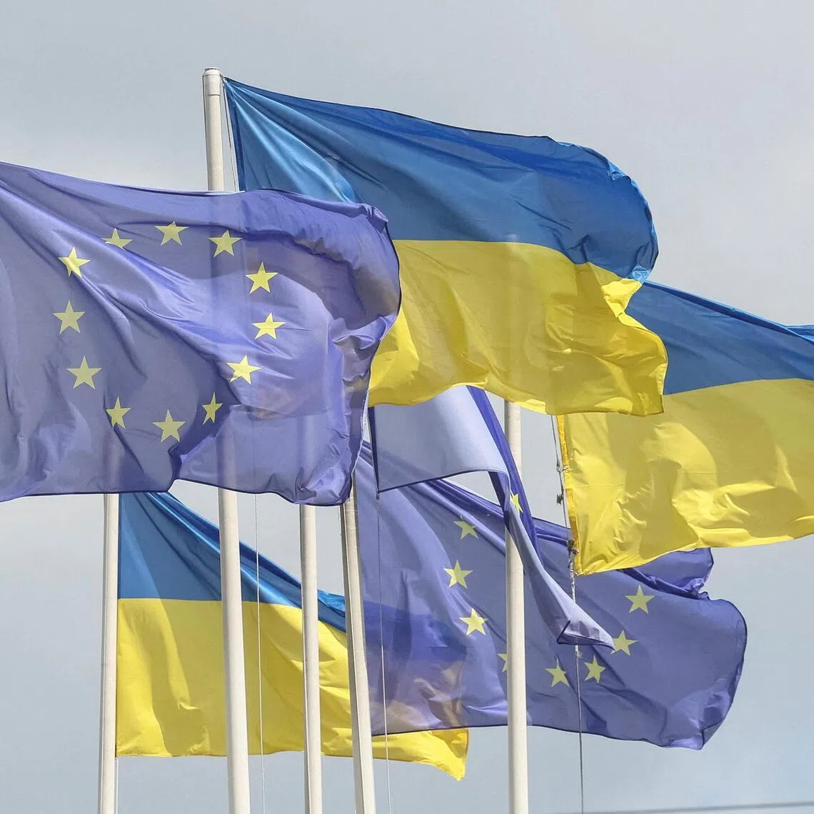 European and Ukrainian flags flying in central Kyiv, Ukraine. The number of tourist visas issued to Russians has risen despite Russia’s war in Ukraine.