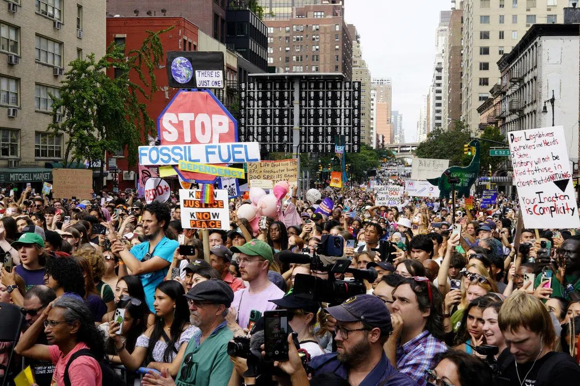 FILE PHOTO: Activists listen to U.S. Representative Alexandria Ocasio-Cortez (D-NY) (not pictured) as they mark the start of Climate Week in New York during a demonstration calling for the U.S. government to take action on climate change and reject the use of fossil fuels in New York City, New York, U.S., September 17, 2023. REUTERS/Eduardo Munoz/File Photo