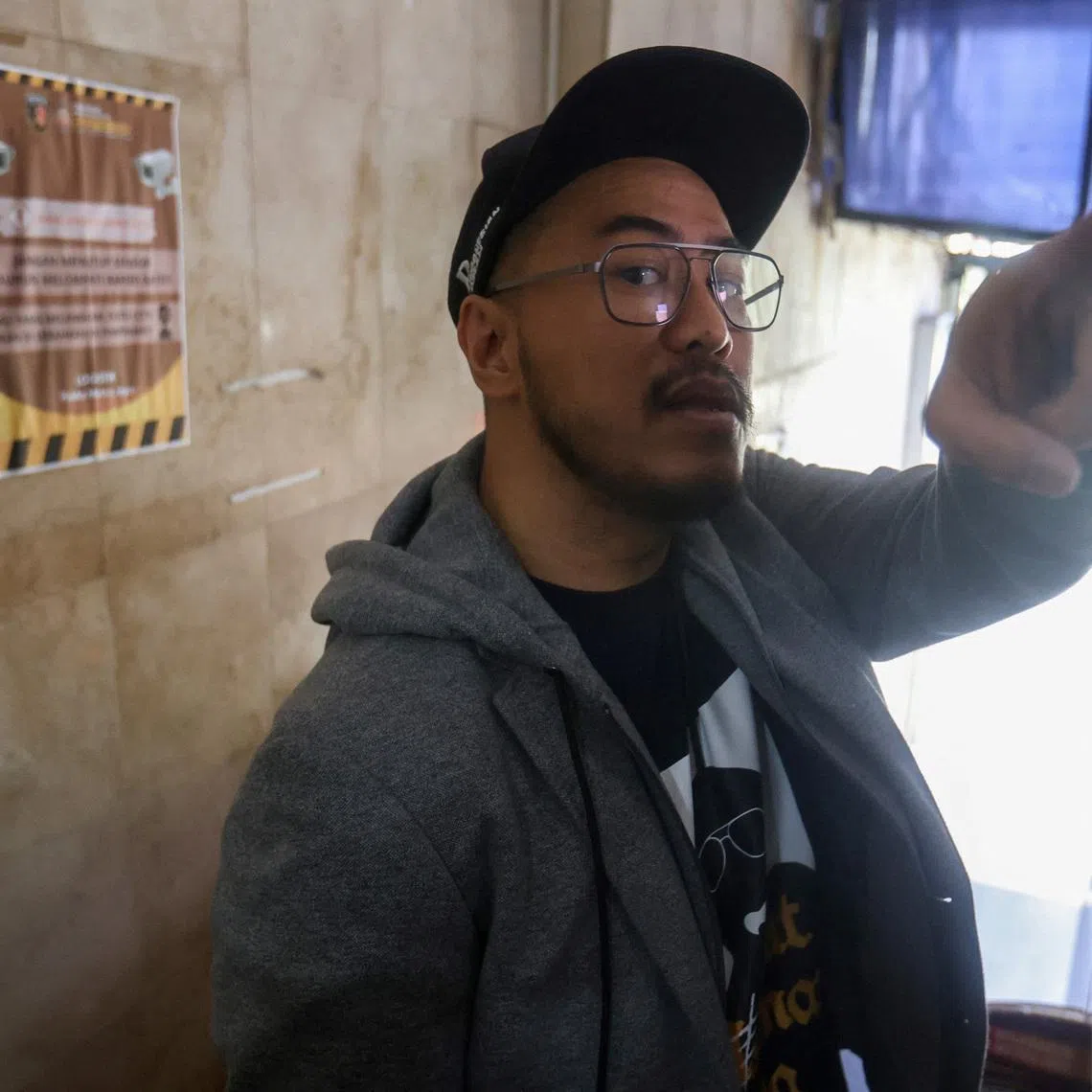Indonesian comedian Pandji Pragiwaksono, who became the first from Indonesia to air a special on Netflix, gestures as he talks to journalists after he summoned by police over what they called public complaints about the material he used in his stand-up act, at Jakarta regional police headquarters in Jakarta, Indonesia, February 6, 2026. REUTERS/Stringer