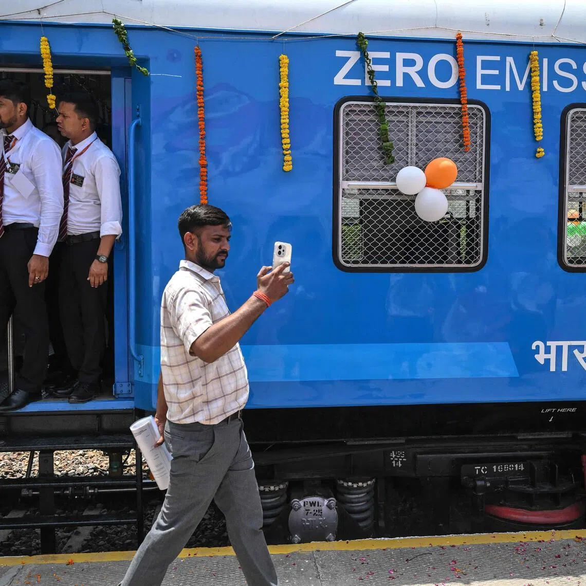 A man takes a selfie with the Indian Railways’ hydrogen-powered train after its flagging-off ceremony at Pandu Pindara railway station on July 17.