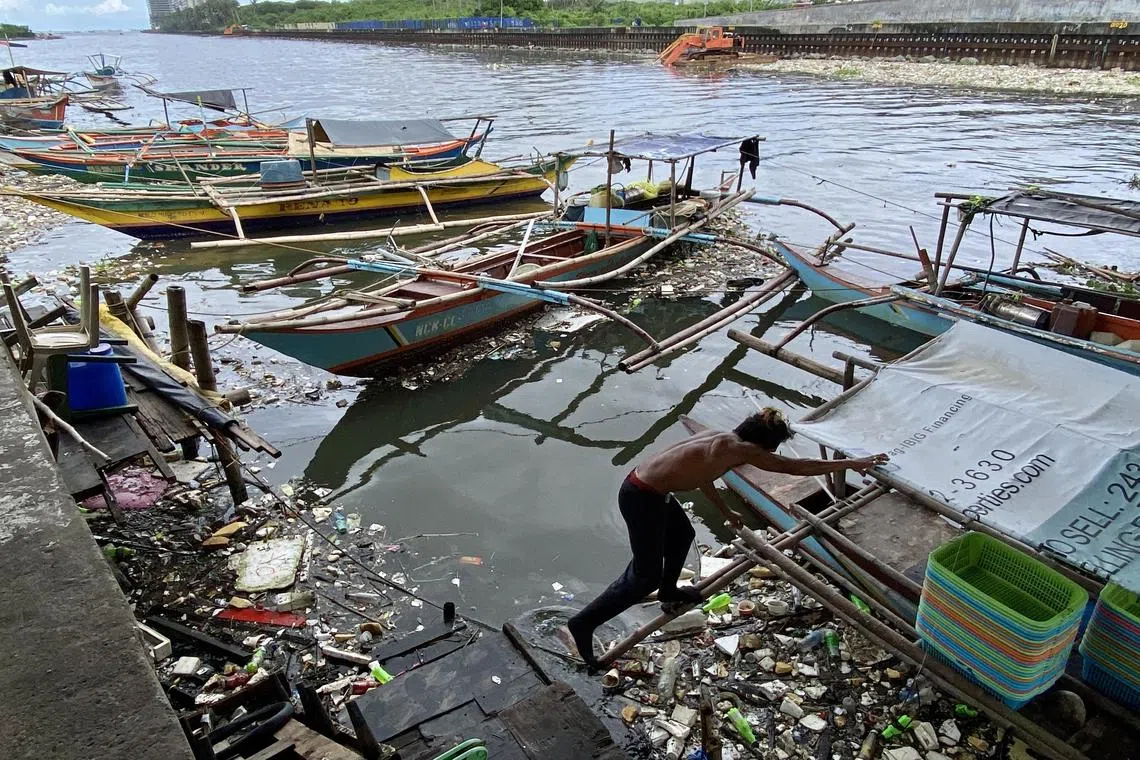 epa10824821 A fisherman secures a boat as a new typhoon is expected to enter the country, at a fishing village in Paranaque city, Metro Manila, Philippines, 28 August 2023. The state weather bureau warned on 28 August, a new typhoon may enter the country with an international name ‘Haikui’ this week as Typhoon Saola dumped rain that brought floods. Saola effect had brought villagers to fled their homes as floods swept through villages in northeastern Philippines.  EPA-EFE/FRANCIS R. MALASIG