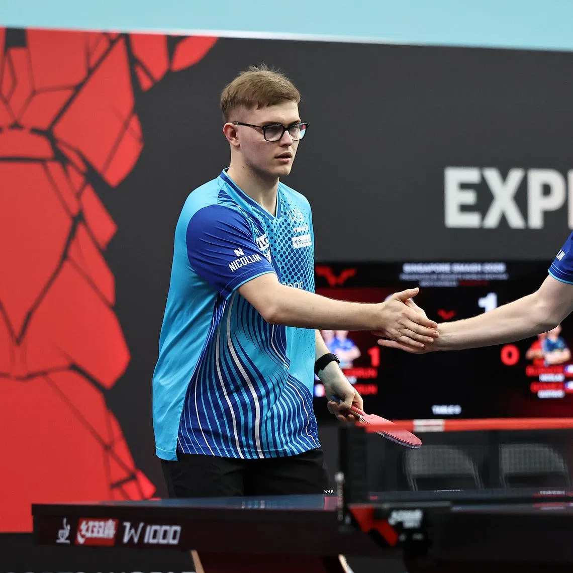 Brothers Alexis (left) and Felix Lebrun exchanging high fives during their men's doubles round-of-16 match at the Singapore Smash on Feb 24.