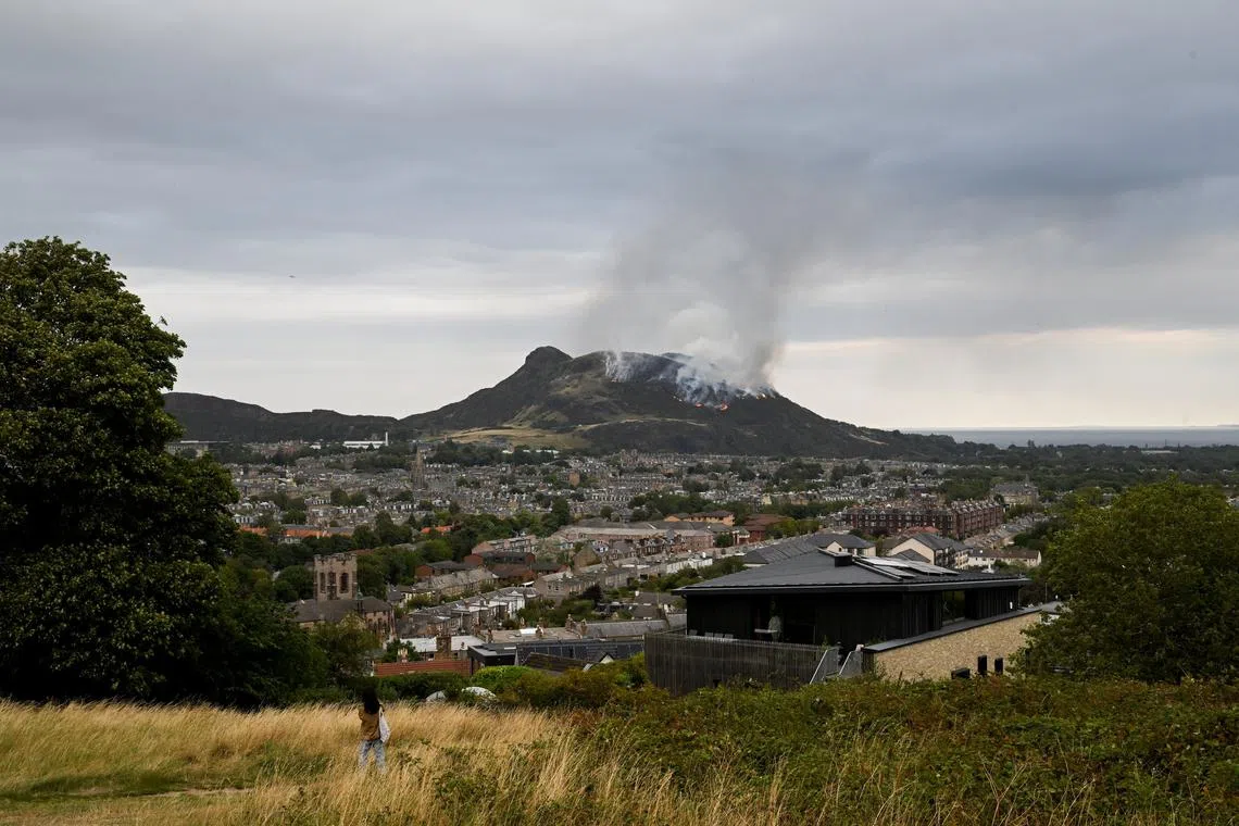 Smoke rises as a wildfire burns at Arthur's Seat in Edinburgh, Scotland, Britain, August 10, 2025. REUTERS/Lesley Martin
