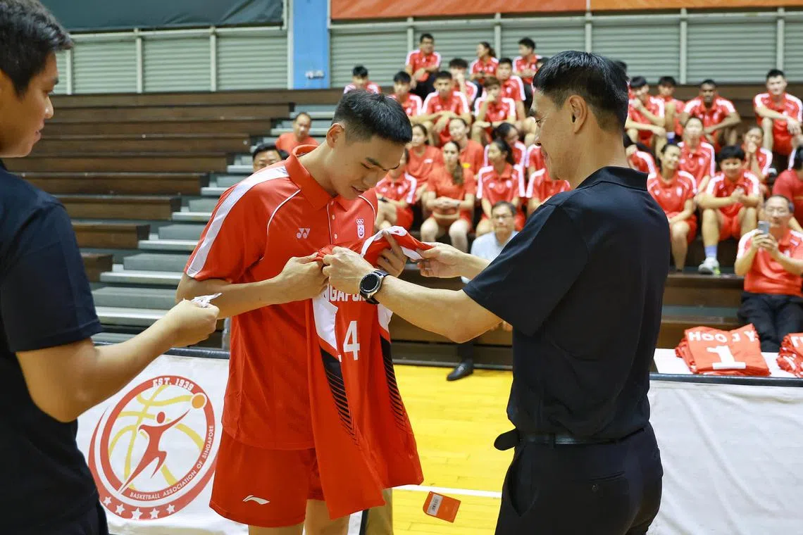 2023 SEA Games men’s 3v3 basketball team captain Branson Tan receiving his jersey from Basketball Association of Singapore’s President Koh Koon Teck during a presentation ceremony at Singapore Basketball Centre on May 2, 2023.

ST PHOTO: KEVIN LIM