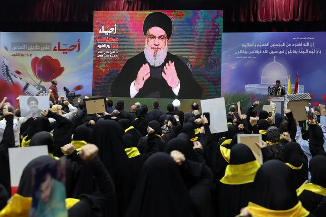 Lebanon's Hezbollah leader Sayyed Hassan Nasrallah addresses his supporters through a screen during a rally commemorating the annual Hezbollah Martyrs' Day, in Beirut's southern suburbs, Lebanon November 11, 2023. REUTERS/Aziz Taher