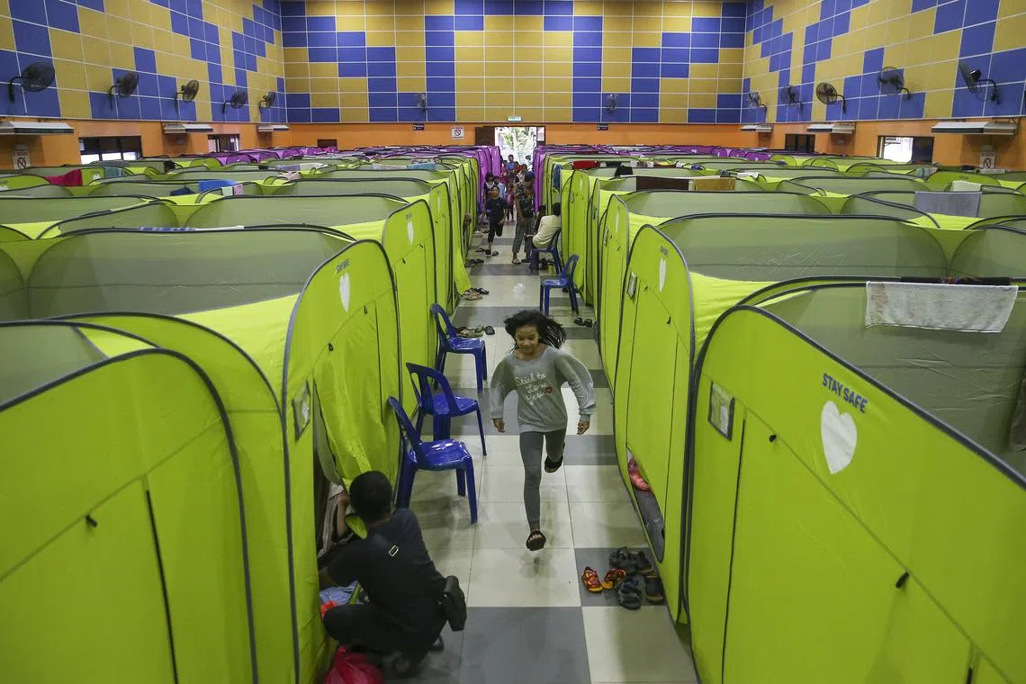 A child runs next to a tent at an evacuation centre after some areas in Johor state were affected by flooding, in Kota Tinggi, Johor, Malaysia, March 5, 2023. 