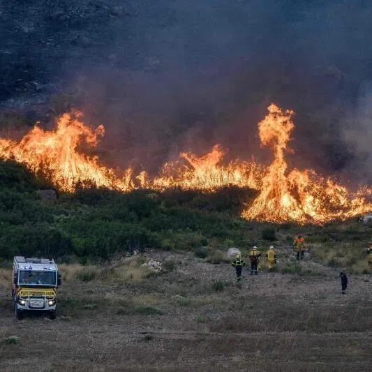 Firefighters working to extinguish a wildfire in the Corbieres massif near Saint-Andre-de-Roquelongue, south-western France, on Aug 6.
