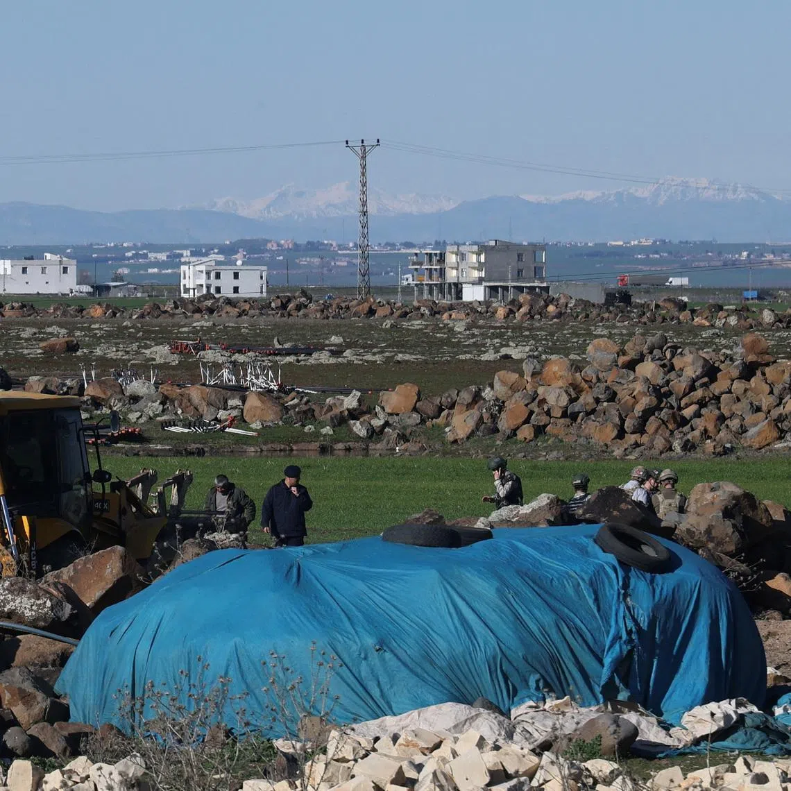 FILE PHOTO: Turkish army personnel search a field after a piece of ammunition fell following the interception of a missile launched from Iran by a NATO air defence system, in Diyarbakir, Turkey, March 9, 2026. REUTERS/Sertac Kayar/File Photo