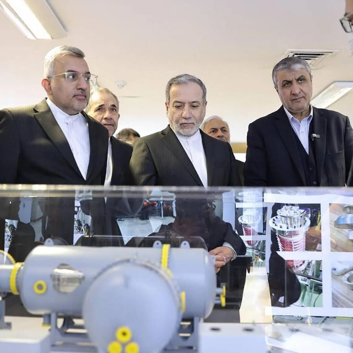 A handout picture made available by the Atomic Energy Organisation of Iran (AEOI) shows Iranian Foreign Minister Abbas Araghchi (centre), accompanied by the head of the AEOI Mohammad Eslami (second from right), during a visit to the organisation on Nov 10. 