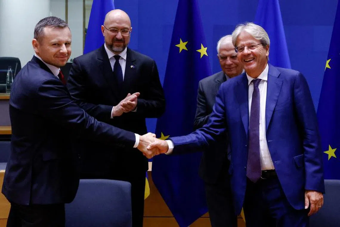 Ukrainian Prime Minister Denys Shmyhal and EU Foreign Policy chief Josep Borrell look on as Ukrainian Finance Minister Sergiy Marchenko shakes hands with European Commissioner for Economy Paolo Gentiloni ahead of a EU-Ukraine Association Council, in Brussels, Belgium September 5, 2022. REUTERS/Yves Herman