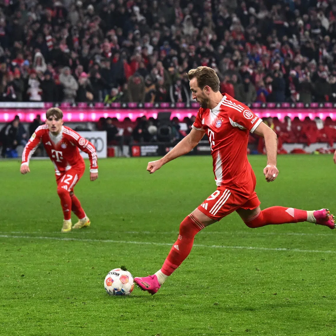 Soccer Football - Bundesliga - Bayern Munich v 1. FSV Mainz 05 - Allianz Arena, Munich, Germany - December 14, 2025  Bayern Munich's Harry Kane scores their second goal from the penalty spot REUTERS/Angelika Warmuth