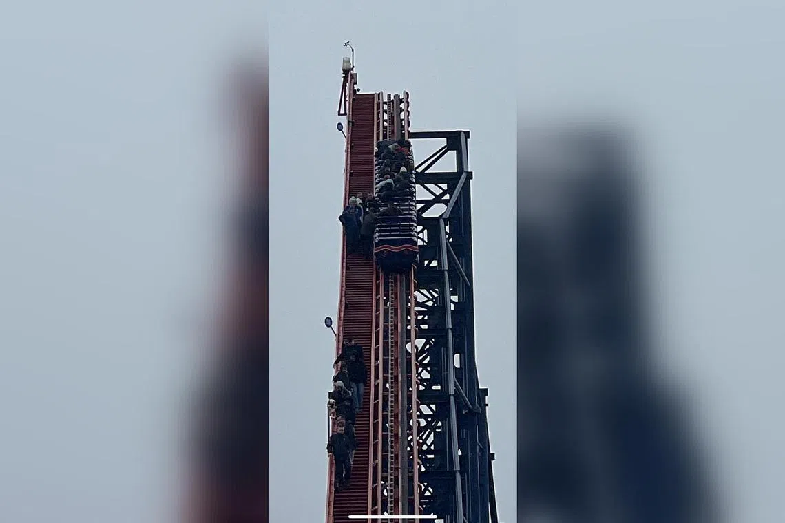 Guests descending from the Big One rollercoaster in Blackpool, after operations were halted due to strong winds, on April 11.