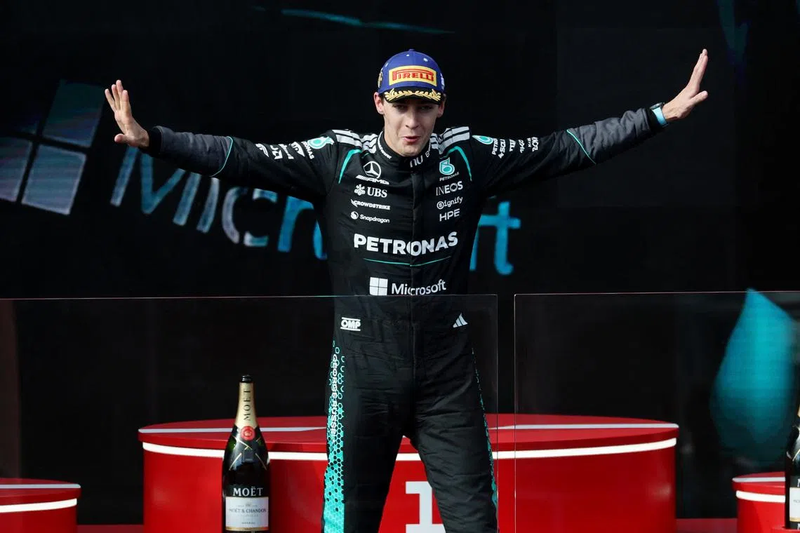 Mercedes' George Russell celebrates on the podium after winning the Australian Grand Prix.
