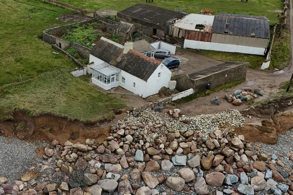 A drone view shows Lal and Willie Pierce's 200-year-old ancestral family home which is at risk of being claimed by the sea due to coastal erosion hastened by climate change, in Ballyhealy, Ireland October 14, 2024. REUTERS/Clodagh Kilcoyne
