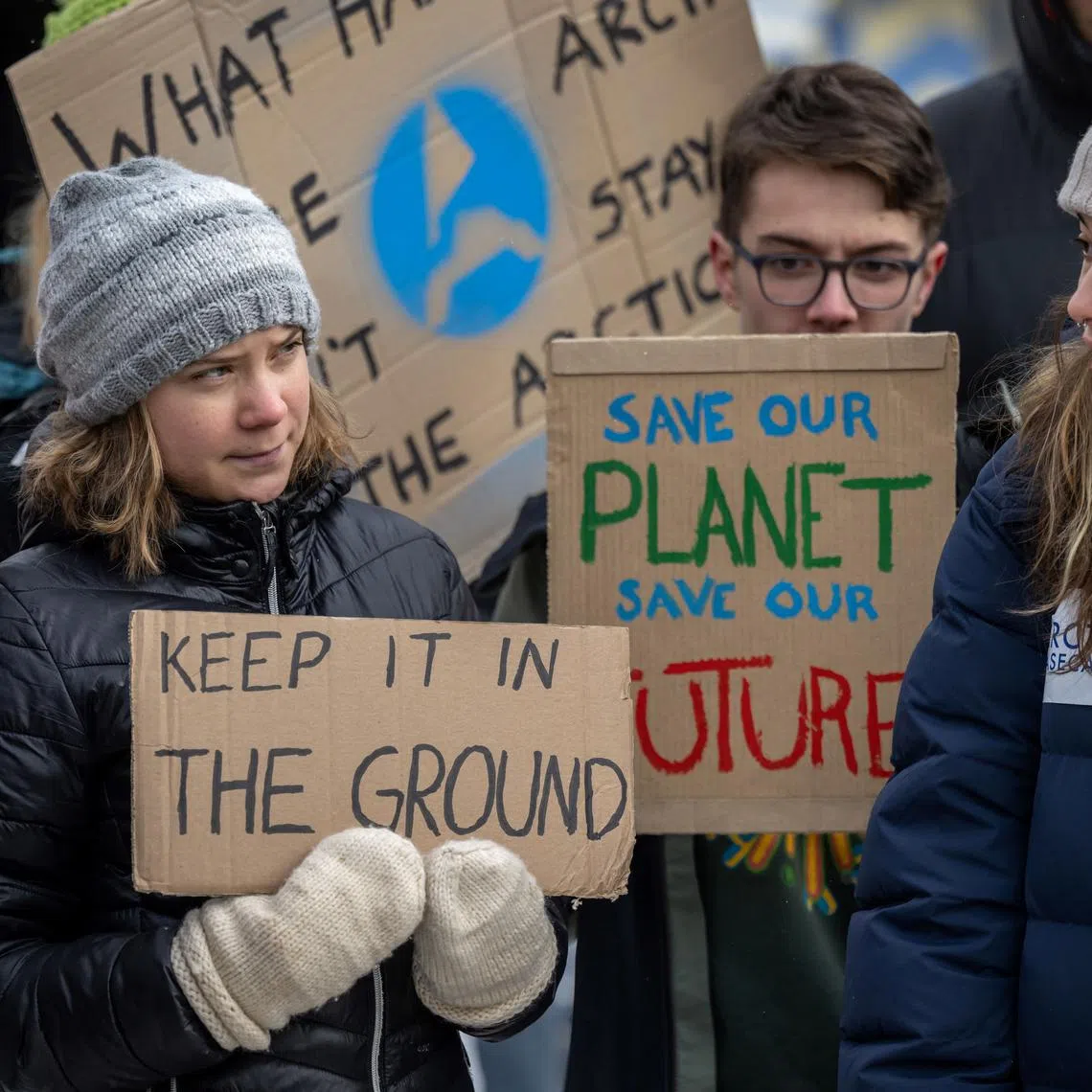 Sweden's Greta Thunberg (left) and other young climate activists of the "Fridays for Future" movement stage an unauthorised demonstration on the closing day of the World Economic Forum (WEF) annual meeting in Davos on Jan 20, 2023. 