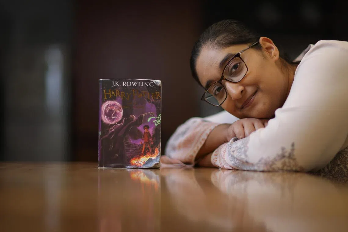 The writer with her copy of Harry Potter and the Deathly Hallows, which she is intentionally taking her time to finish.