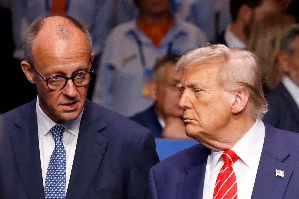 Germany's Chancellor Friedrich Merz speaks with US President Donald Trump before the start of the North Atlantic Council plenary meeting at the North Atlantic Treaty Organisation (NATO) summit in The Hague on June 25, 2025.      LUDOVIC MARIN/Pool via REUTERS/File Photo