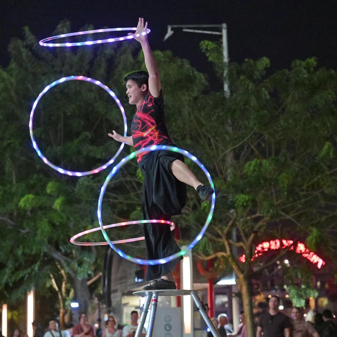 Busker Bryan Wong performing at Clarke Quay. Mr Wong dazzles his watchers with acrobatic stunts using props like a Leviwand – a stick that appears to float on an almost invisible string – and hula hoops.