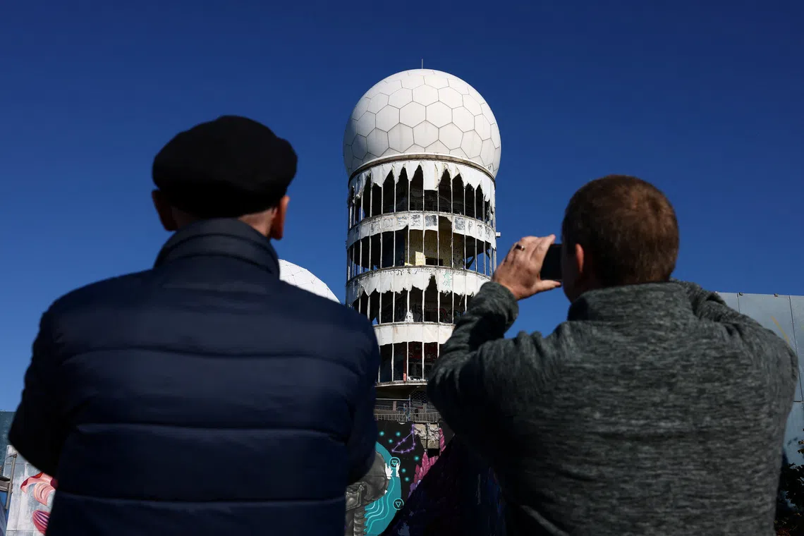 A group of former British conscripts, once stationed at the Teufelsberg U.S. listening and radar station, return to their former post to reminisce about their work in the divided city during the Cold War, in Berlin, Germany, September 24, 2025. REUTERS/Christian Mang