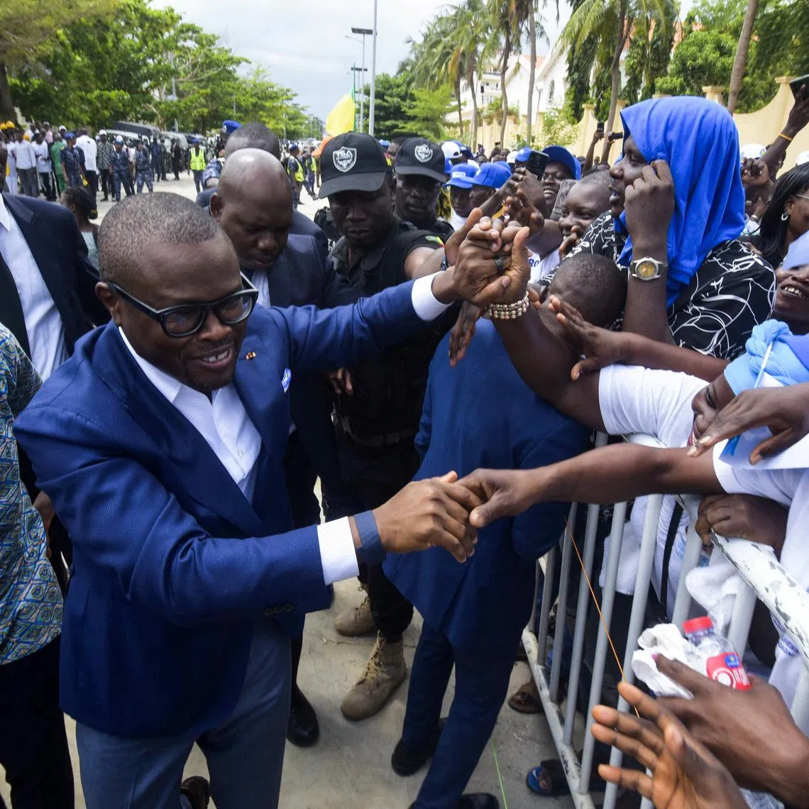 Romuald Wadagni, Benin's finance minister and the ruling party candidate for the presidential election, shakes hands with supporters after presenting his platform in Cotonou, Benin March 21, 2026. REUTERS/Charles Placide Tossou