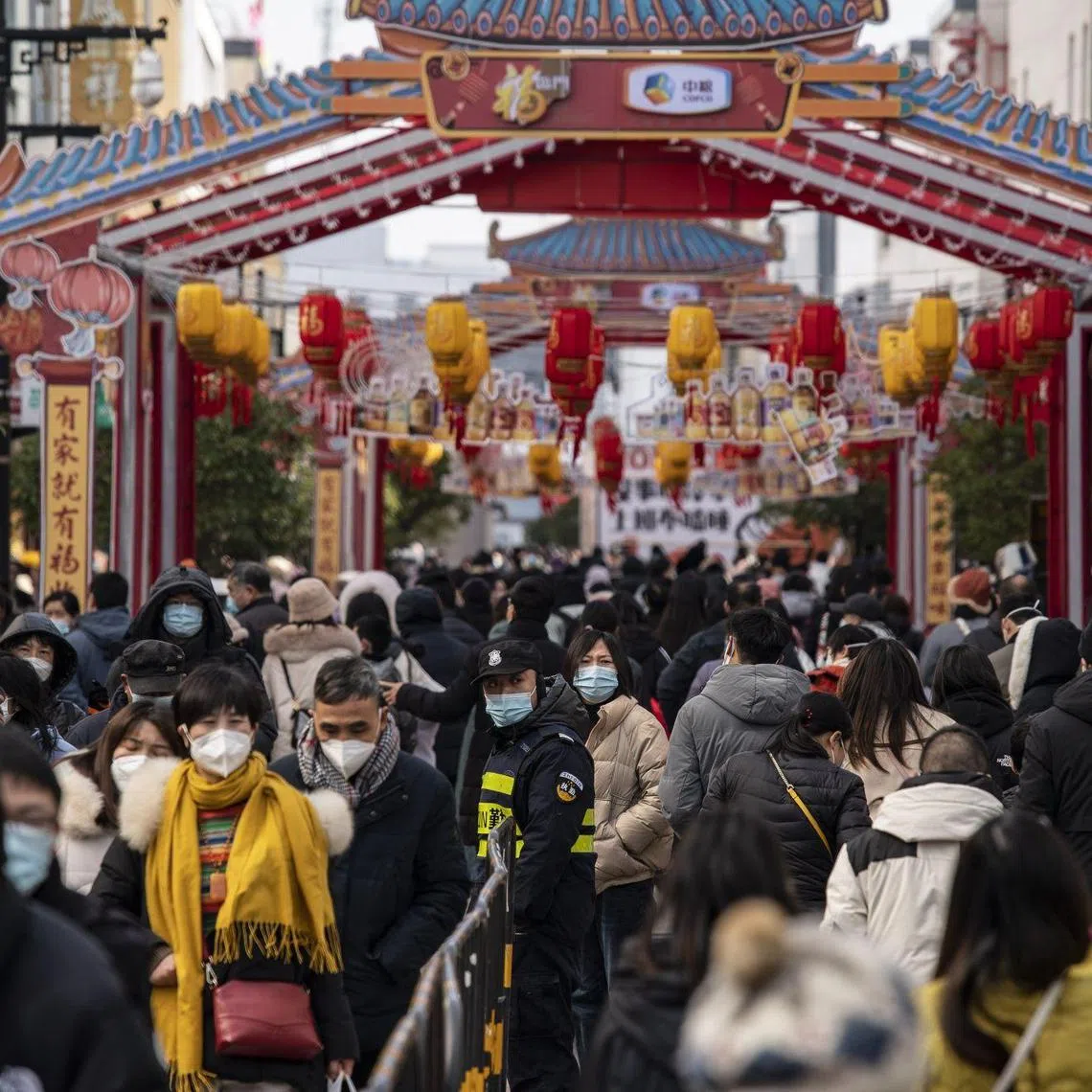 Shoppers in the Guanqian Street shopping area of Suzhou, Jiangsu province, China, on Jan 25, 2023.