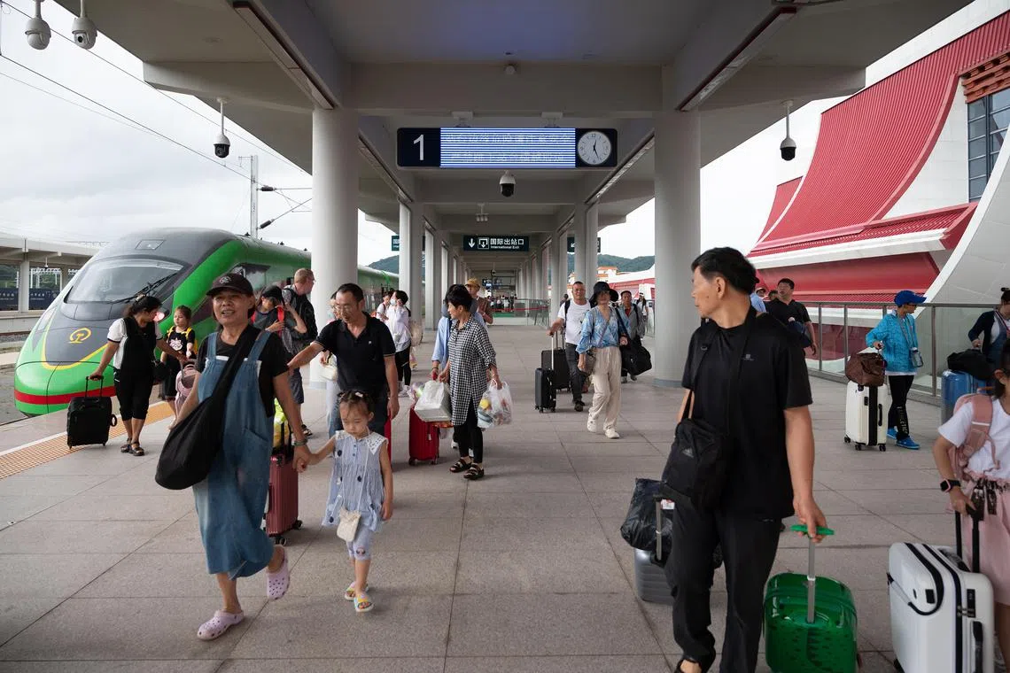 hyground - Commuters arriving at Mohan Station, in Yunnan province, which is the end of the Chinese section of the China-Laos Railway. On the far left is the train that ferries passengers between China and Laos. Taken in late-July 2023. credit all photos to myself (ST PHOTO: LIM MIN ZHANG).