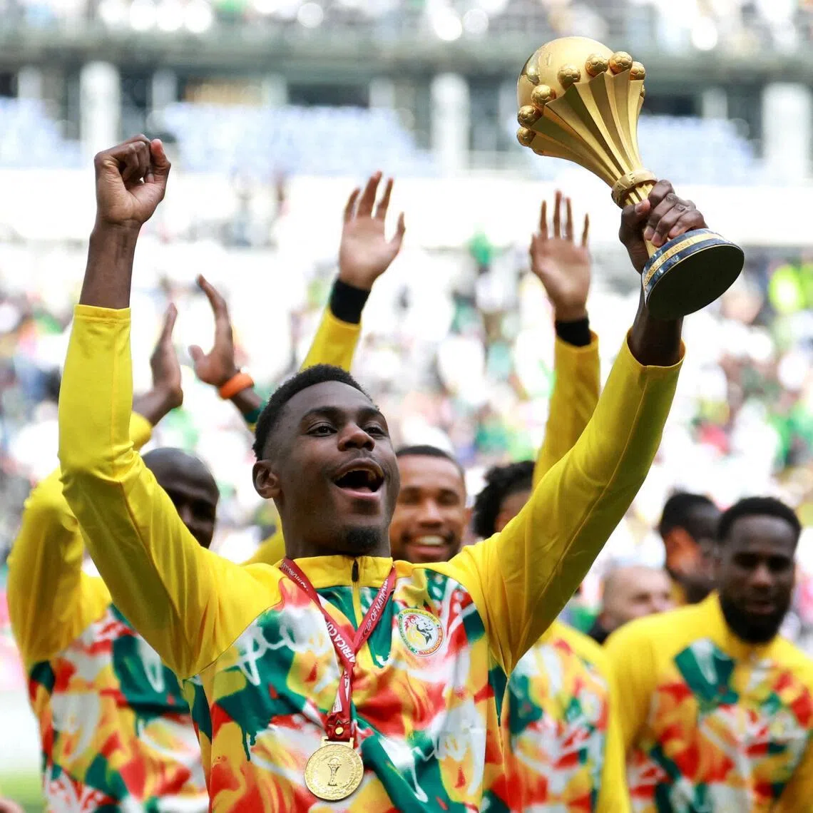 Senegal's Moussa Niakhate holding aloft the Africa Cup of Nations trophy before their World Cup friendly against Peru on March 28.