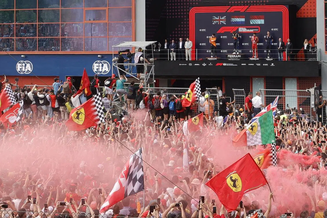 Formula One F1 - Emilia Romagna Grand Prix - Autodromo Enzo e Dino Ferrari, Imola, Italy - May 19, 2024 General view of Ferrari fans as Red Bull's Max Verstappen celebrates on the podium after winning the Emilia Romagna Grand Prix along with second placed McLaren's Lando Norris and third placed Ferrari's Charles Leclerc REUTERS/Ciro De Luca