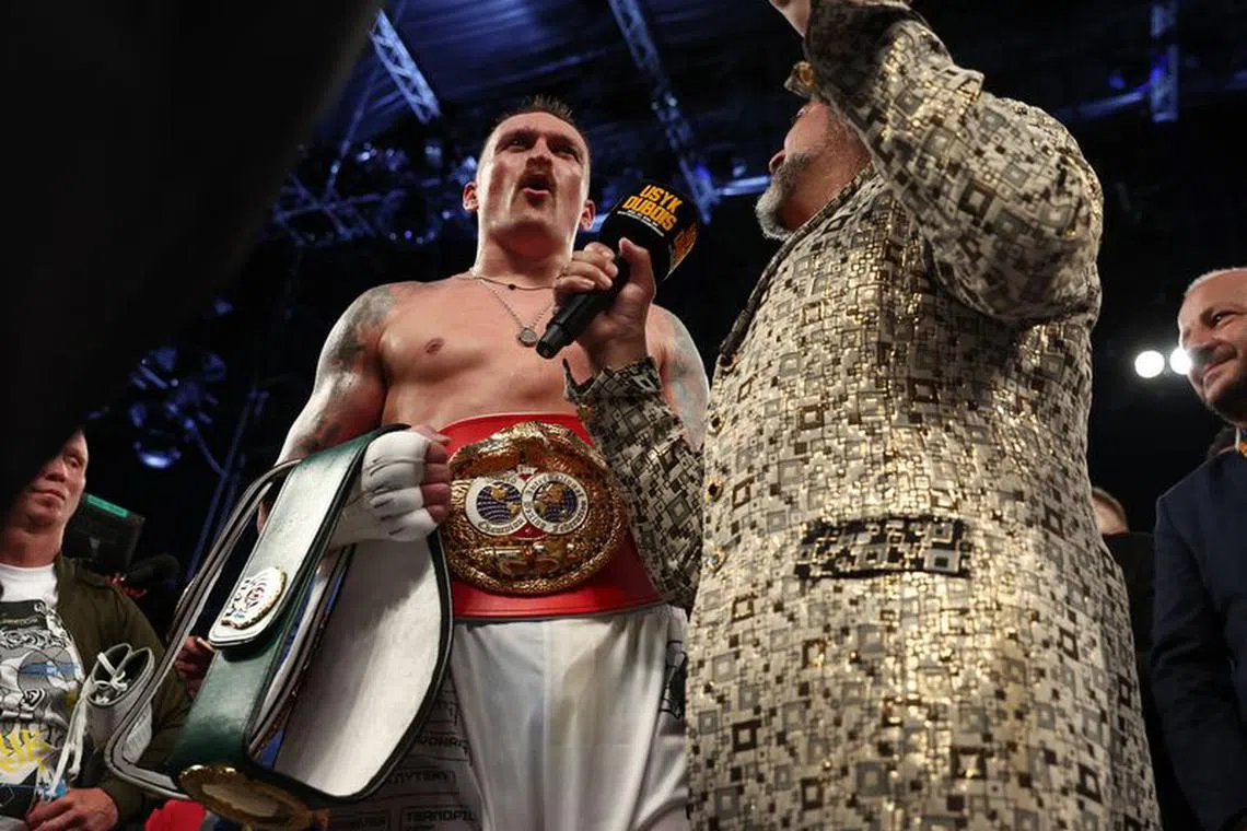 Boxing - WBA, IBF & WBO Heavyweight Titles - Oleksandr Usyk v Daniel Dubois - Tarczynski Arena, Wroclaw, Poland - August 26, 2023  Oleksandr Usyk celebrates with the belts after winning his fight against Daniel Dubois REUTERS/Kacper Pempel