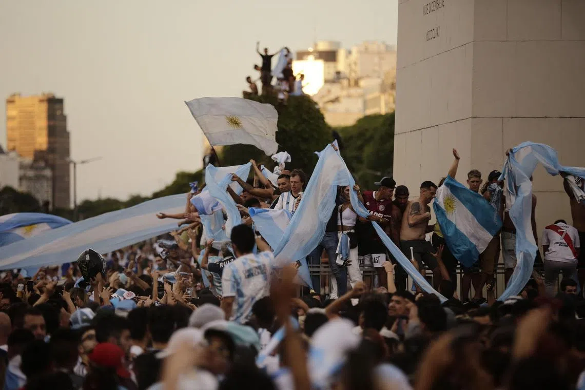 Fans of Argentina celebrate their team's victory at the Obelisk in Buenos Aires on Dec 13, 2022. 