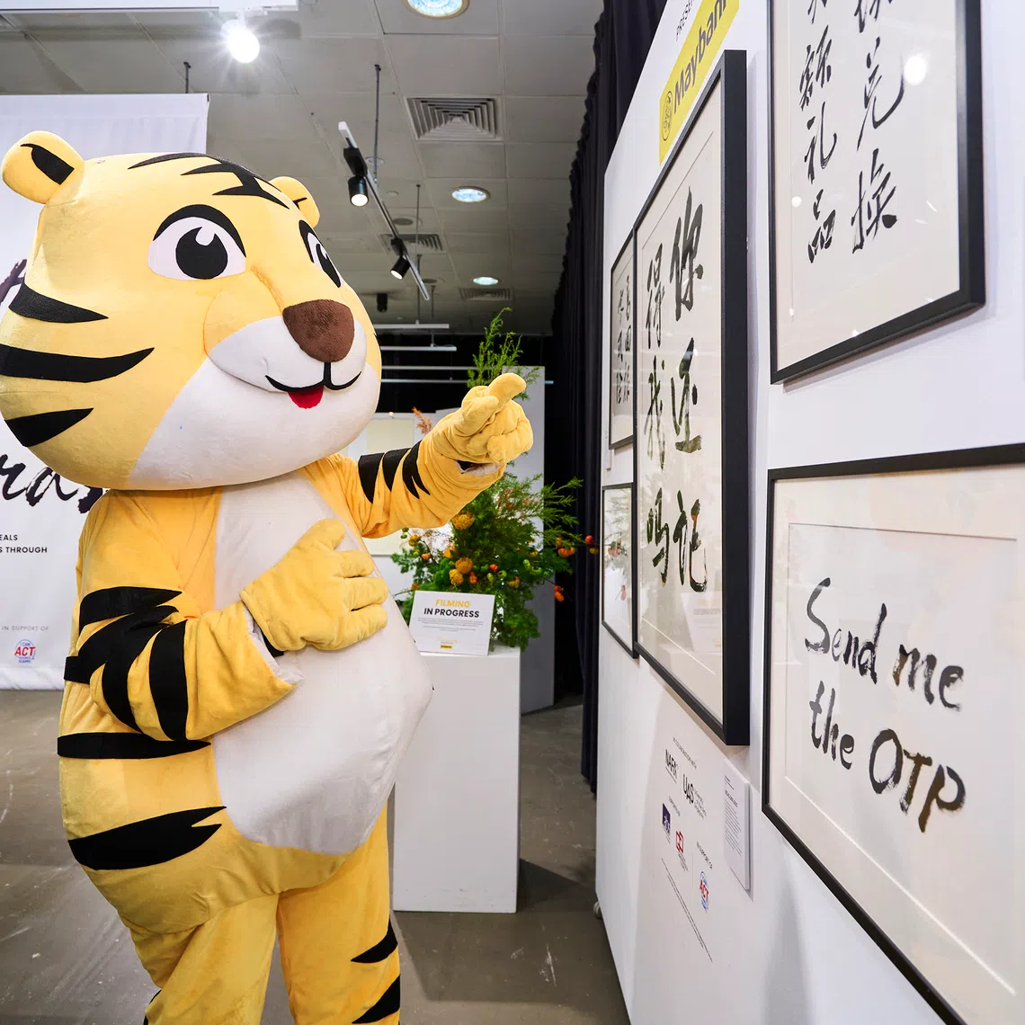 Tabby The Tiger, a Maybank mascot, appreciating The Most Expensive Words, a special art exhibition held at Nanyang Academy of Fine Arts Centre for Lifelong Education.