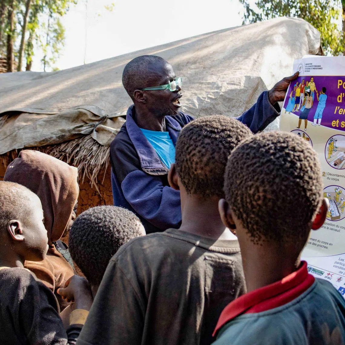 FILE PHOTO: Dz'na Lipe Jean‑Marie, secretary of the displacement camp, speaks during an Ebola awareness session as humanitarian agencies intensify efforts to contain a new Ebola outbreak involving the Bundibugyo strain, at Kpangba displacement camp where Ebola cases were observed, Djugu territory in Ituri province, Democratic Republic of Congo, June 13, 2026. REUTERS/Gradel Muyisa Mumbere./File Photo