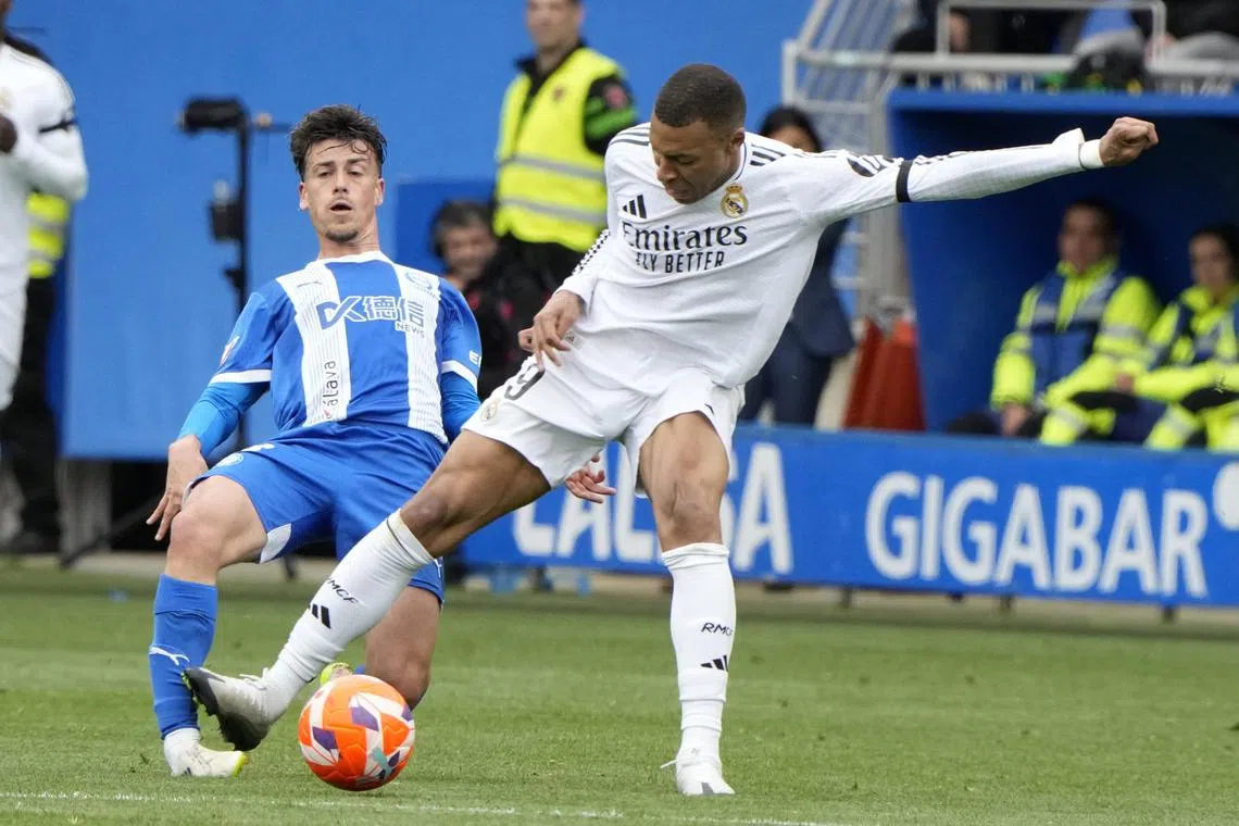 Kylian Mbappe (right) in action against Alaves' Antonio Blanco during Real Madrid's 1-0 La Liga win on April 13 at the Mendizorroza. Mbappe was sent off in the match.