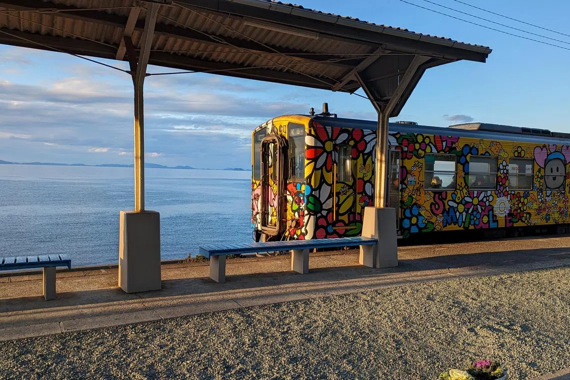A brightly coloured train leaving Shimonada Station in Shikoku, the smallest of Japan's four main islands.