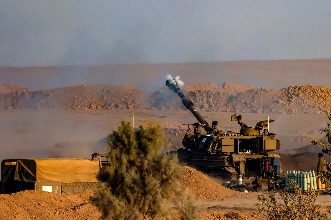 epa10949990 Israel Defense Forces (IDF) soldiers fire a 155 mm howitzer at an undisclosed location near the border with the Gaza Strip, southern Israel, 31 October 2023. Over the last day Israeli forces struck approximately 300 targets as part of its 'expanded ground operations' in the Gaza Strip, the Israel Defense Forces (IDF) said on 31 October. More than 8,000 Palestinians and at least 1,400 Israelis have been killed, according to the IDF and the Palestinian health authority, since Hamas militants launched an attack against Israel from the Gaza Strip on 07 October, and the Israeli operations in Gaza and the West Bank which followed it.  EPA-EFE/HANNIBAL HANSCHKE