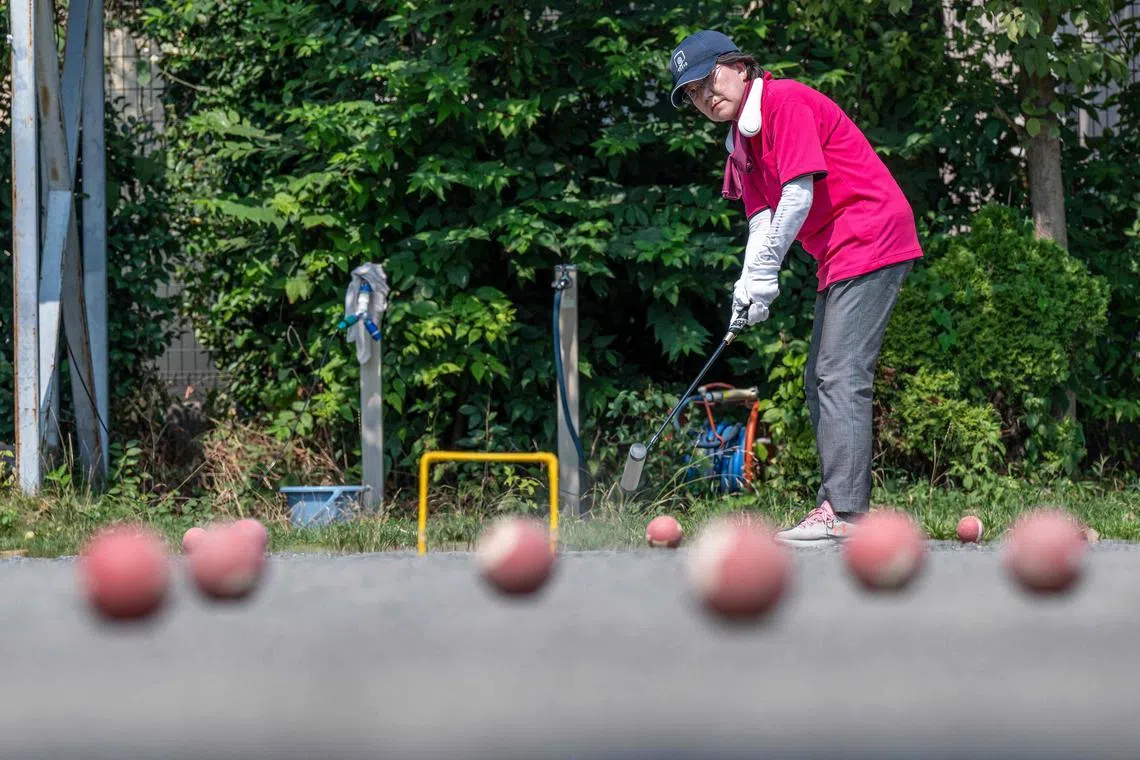 This photo taken on July 27, 2023 shows a senior citizen practising the croquet-inspired game of "gateball" at a park in suburban Tokyo, as temperatures of 36C-plus (97F)  scorched the Japanese capital. Japan is home to a legion of elderly devotees of the croquet-inspired game, and near-record heatwaves that have gripped the nation in recent weeks are nowhere near enough to convince them to stay cool at home. (Photo by Richard A. Brooks / AFP) / To go with 'JAPAN-WEATHER-SENIOR CITIZENS-GATEBALL,FOCUS' by Tomohiro OSAKI
