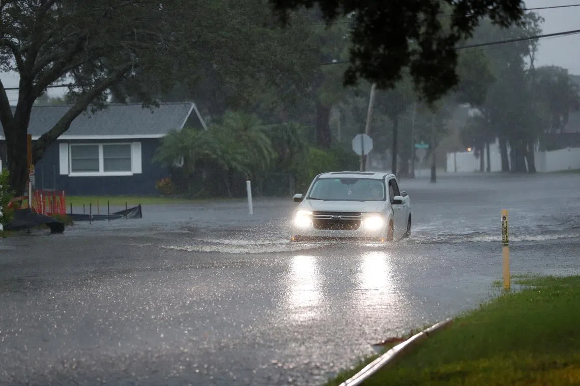 A truck drives through high water in the the Shore Acres neighborhood located on the Tampa Bay while Tropical Storm Debby moves up the gulf coast in St. Petersburg, Florida, U.S., August 4, 2024. REUTERS/Octavio Jones
