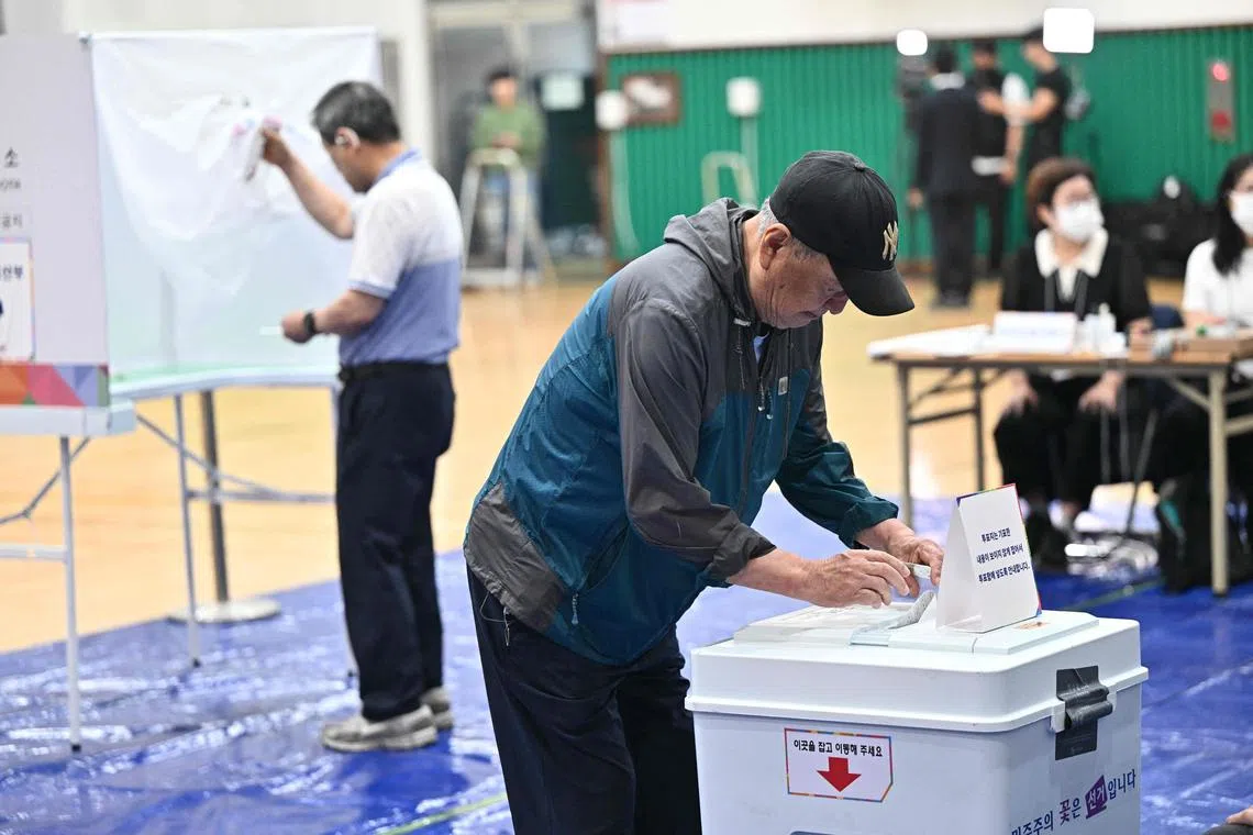 A man casts his vote at a polling station in Seoul during the presidential election on June 3, 2025. 