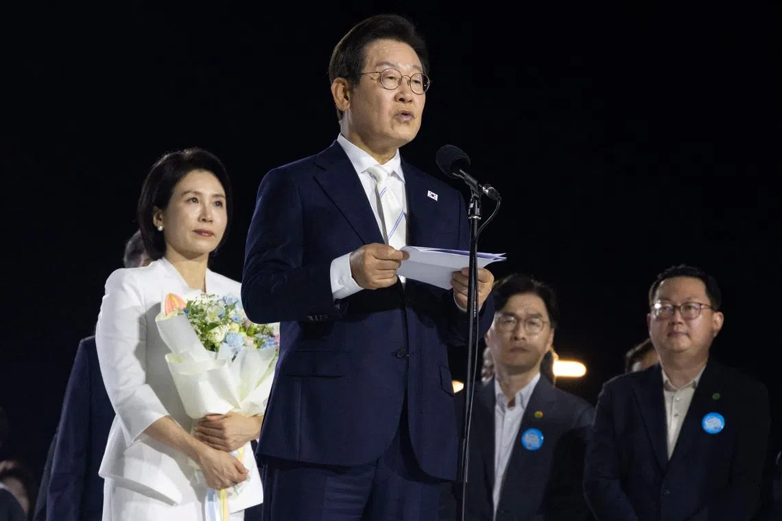 South Korean President Lee Jae-Myung (C) speaks after receiving letters of appointment during a “people’s appointment ceremony”, which is the inauguration ceremony at Gwanghwamun Square in Seoul on August 15, 2025. (Photo by JEON HEON-KYUN / POOL / AFP)