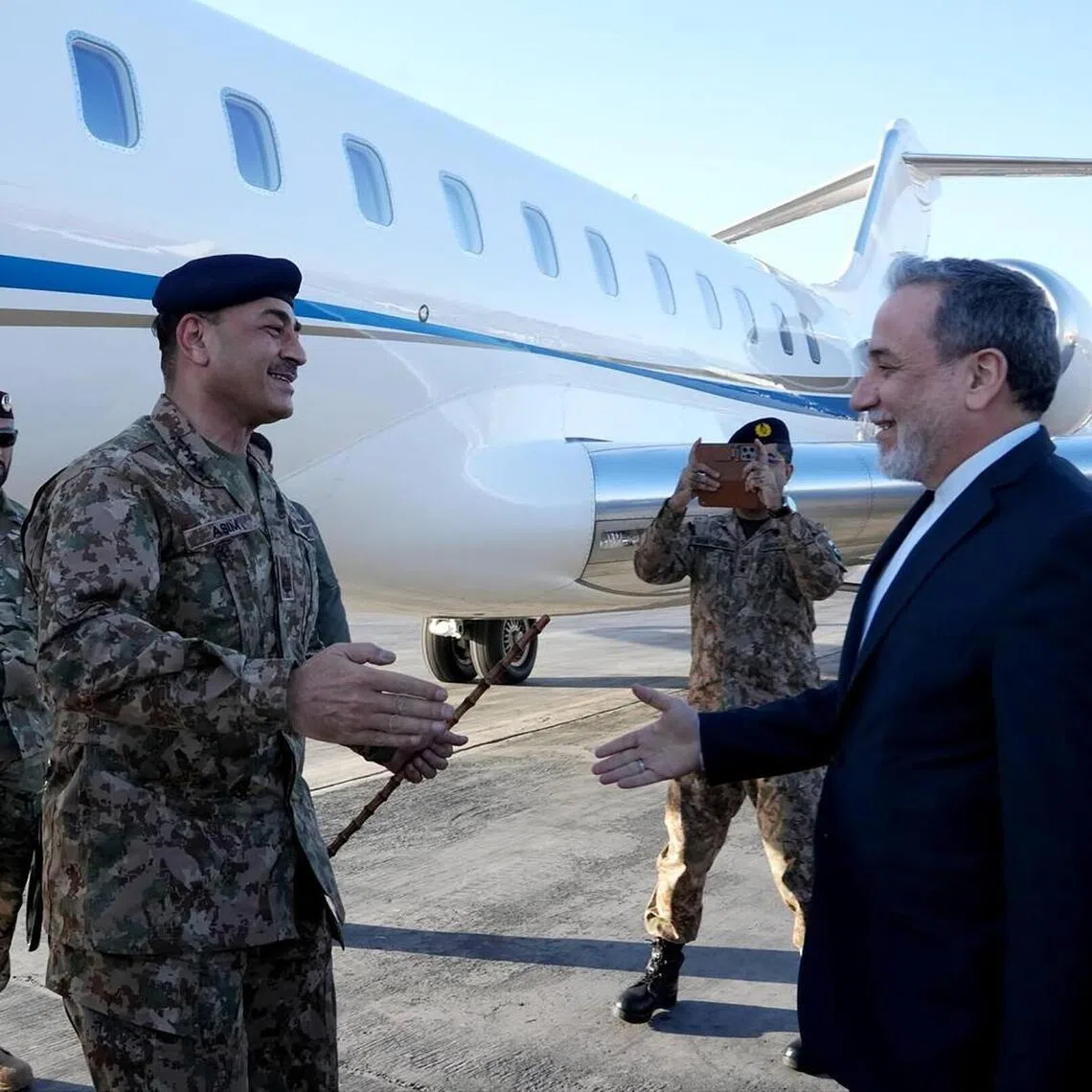 Iranian Foreign Minister Abbas Araghchi (right) welcoming Pakistan's Chief of Army Staff, Field Marshal Asim Munir, at an airport in Tehran, Iran, on April 15. 