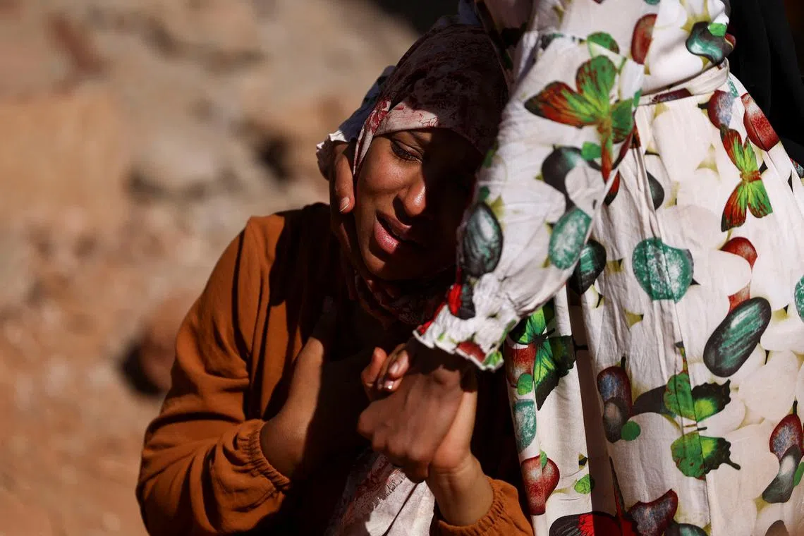 A relative reacting as rescue workers recover one body from the rubble, in the aftermath of a deadly earthquake in Ouirgane, Morocco, Sept 10, 2023. 