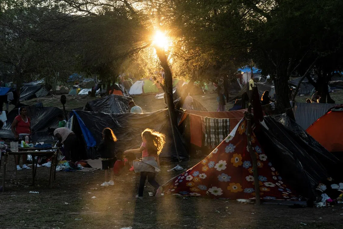 Asylum-seeking migrants, mostly from Venezuela, camp in a park by the Rio Grande river, on the day after the COVID-era Title 42 U.S. migration restrictions were set to end, until the U.S. Supreme Court ruled to let the policy temporarily stay in place, in Matamoros, Mexico, December 22, 2022. 