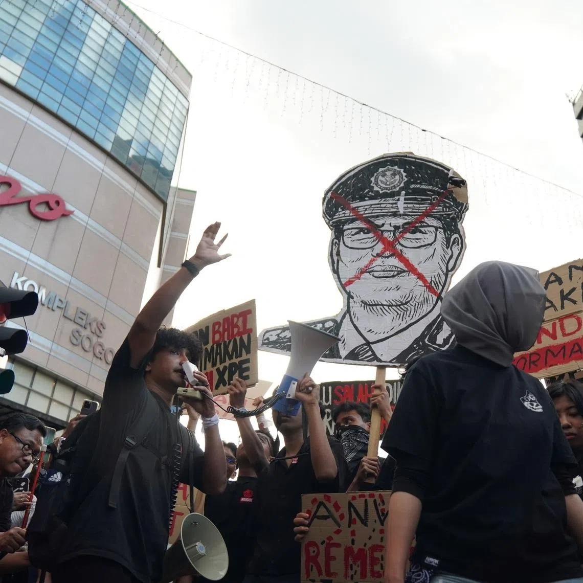 The crowd of mainly young people waved black flags and placards as they assembled outside a shopping mall in the heart of Kuala Lumpur.