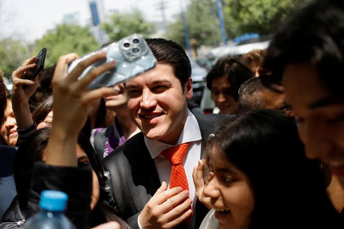 FILE PHOTO: Governor of Nuevo Leon state Samuel Garcia poses for a picture with students as he arrives at an event of school equipment delivery at the Prepa Tec high school, in Monterrey, Mexico April 25, 2023. REUTERS/Daniel Becerril/File Photo