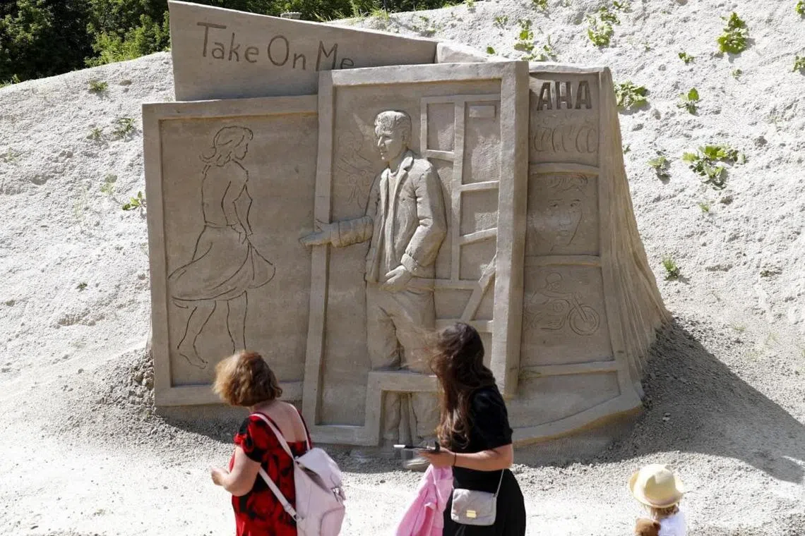 A sand sculpture called A-ha Take On Me, made by Lithuanian artist Tautvilas Povilionis, on display during the International Sand Sculpture Festival on Pasta Island in Jelgava, Lastvia, on July 18, 2023. On the Island, 17 sculptors from nine countries created their sand masterpieces recreating global music hits. The sculptures can be viewed throughout the summer.