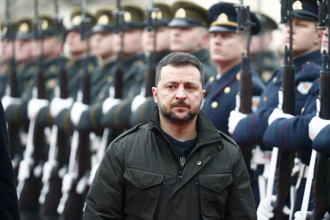 Ukrainian President Volodymyr Zelensky inspects a guard of honour, during an unannounced visit to Lithuania.