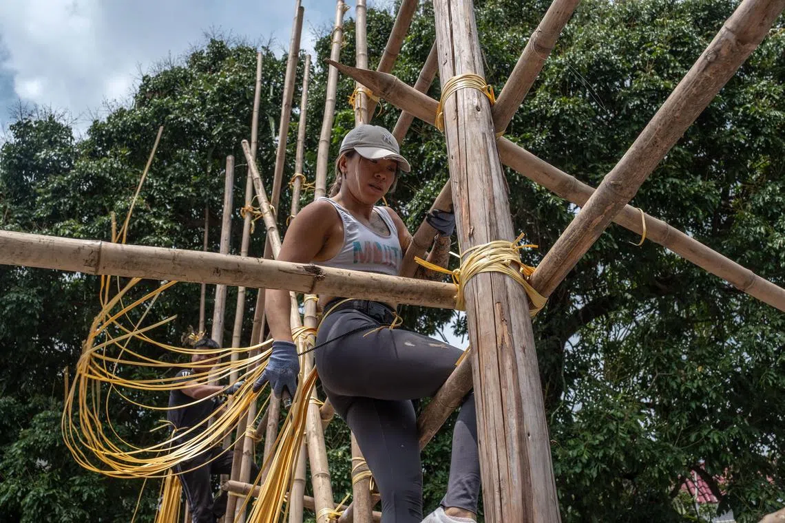 **EMBARGO: No electronic distribution, Web posting or street sales before Saturday at 5 a.m. ET on May 24, 2025. No exceptions for any reasons. EMBARGO set by source.** Daisy Pak, one of a small number of women in the cityÕs bamboo scaffolding industry, uses zip ties to tie together bamboo poles to fir-lumber pillars in Hong Kong, May 4, 2025. In Hong Kong, one of the last bastions of the distinctive practice, a bureau recently issued a memo requiring metal scaffolding for at least half of government projects, an effort to speed up adoption of modern industry practices and safety standards. (Lam Yik Fei/The New York Times)
